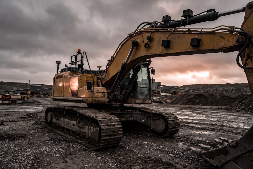 A large yellow heavy machine fitted with sensors on a worksite